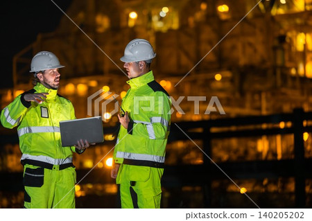 Professional Engineer Team Working at Refinery plant background twilight evening. Oil Gas Energy man Professional Engineer Team Working at Refinery plant background twilight evening. Oil Gas Energy man 140205202