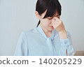 A woman suffering from eye strain due to computer work. 140205229