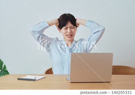 A woman is troubled by work-related problems. 140205331
