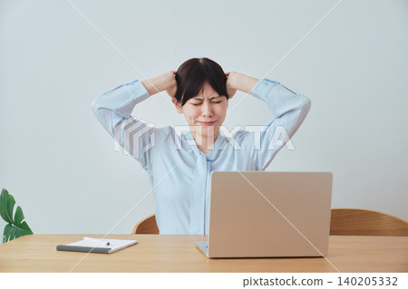 A woman is troubled by work-related problems. A woman is troubled by work-related problems. 140205332