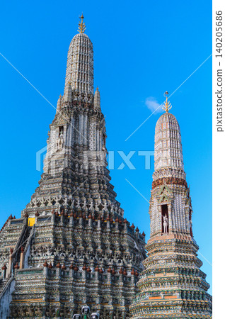 Wat arun temple dawn bangkok chao phraya river ancient spire under clear blue sky with calm spiritual beauty Wat arun temple dawn bangkok chao phraya river ancient spire under clear blue sky with calm spiritual beauty 140205686