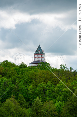 Humprecht Castle in Sobotka, Cesky Raj, rises above forests and fields under dramatic dark clouds. Baroque tower-like shape 17th century hunting lodge now museum and concert hall Humprecht Castle in Sobotka, Cesky Raj, rises above forests and fields under dramatic dark clouds. Baroque tower-like shape 17th century hunting lodge now museum and concert hall 140205705