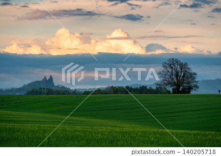 Panoramic view of Cesky Raj in Czech Republic with Trosky Castle ruins on twin basalt rocks. Sunset lights the clouds orange, a popular landmark above rolling countryside. Panoramic view of Cesky Raj in Czech Republic with Trosky Castle ruins on twin basalt rocks. Sunset lights the clouds orange, a popular landmark above rolling countryside. 140205718