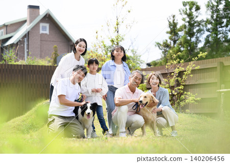Family and dog relaxing in the garden Family and dog relaxing in the garden 140206456