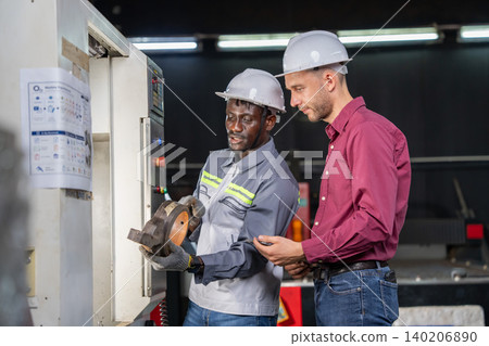 Collaborative equipment setup manufacturing facility instructional interaction industrial environment close-up view workplace safety Collaborative equipment setup manufacturing facility instructional interaction industrial environment close-up view workplace safety 140206890
