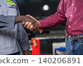 Handshake between business partners in workplace professional interaction indoor setting close-up perspective 140206891