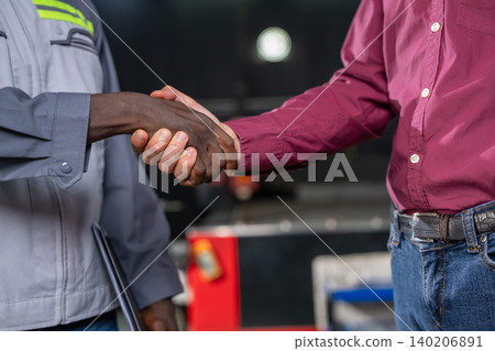 Handshake between business partners in workplace professional interaction indoor setting close-up perspective Handshake between business partners in workplace professional interaction indoor setting close-up perspective 140206891