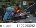 Welding action in workshop metal fabrication scene industrial environment close-up view skilled craftsmanship 140206892