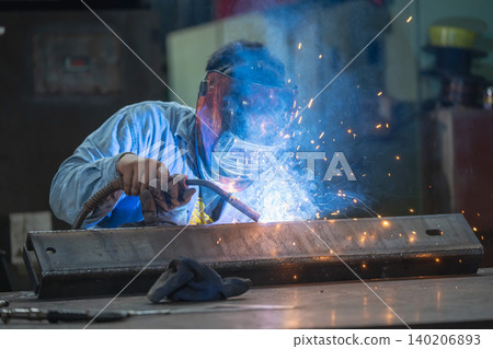 Welding action industrial workshop craftsmanship photography bright sparks close-up view metalwork techniques 140206893