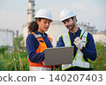Engineers collaborating on project in industrial setting digital workspace outdoor environment professional focus 140207403