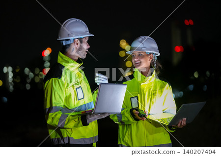Nighttime collaboration engineers using technology industrial site photo urban environment close-up innovation Nighttime collaboration engineers using technology industrial site photo urban environment close-up innovation 140207404