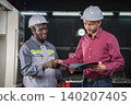 Collaboration between engineers and technicians manufacturing facility business meeting indoor setting professional interaction 140207405