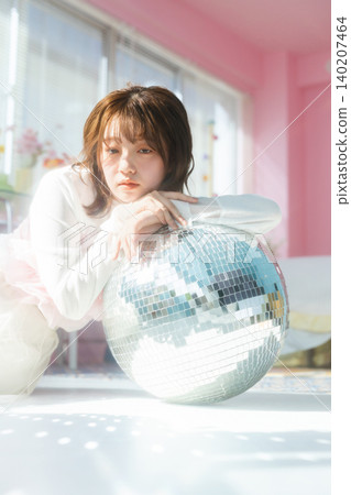 A woman in her twenties gazes with an ennui-filled look. 140207464