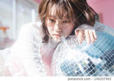 A young woman gazes with an ennui-filled look. A young woman gazes with an ennui-filled look. 140207465