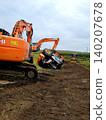 Restoration work using overturned agricultural machinery and heavy equipment on farmland. 140207678