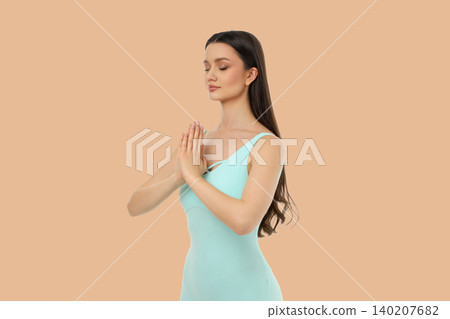 Yoga pose with hands in prayer position, standing still Yoga pose with hands in prayer position, standing still 140207682