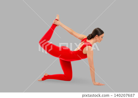 Yoga activity shows a person stretching indoors in a red outfit Yoga activity shows a person stretching indoors in a red outfit 140207687