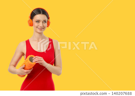 Yoga session with fitness gear and headphones in bright space 140207688