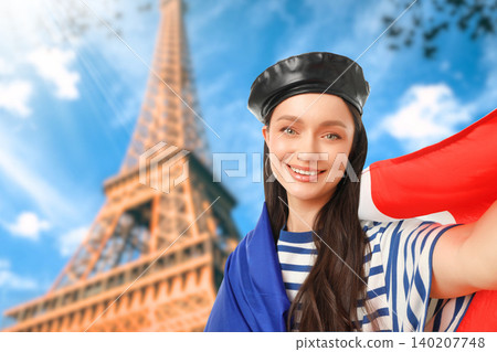 Woman smiles with flag at Eiffel Tower. Vacation and travel concept 140207748