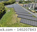 As technical documentation, an aerial photograph of a solar power plant taken from a diagonal angle above. 140207843