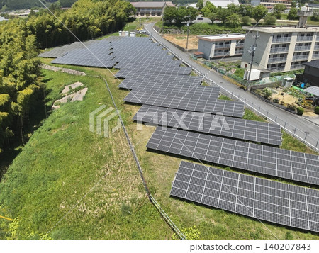 As technical documentation, an aerial photograph of a solar power plant taken from a diagonal angle above. As technical documentation, an aerial photograph of a solar power plant taken from a diagonal angle above. 140207843