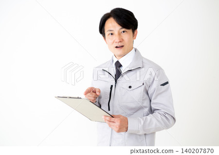A middle-aged businessman in gray work clothes looks surprised when he sees the documents. (White background) A middle-aged businessman in gray work clothes looks surprised when he sees the documents. (White background) 140207870