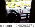 A child waving from the castle tower and a tourist scene. 140208871