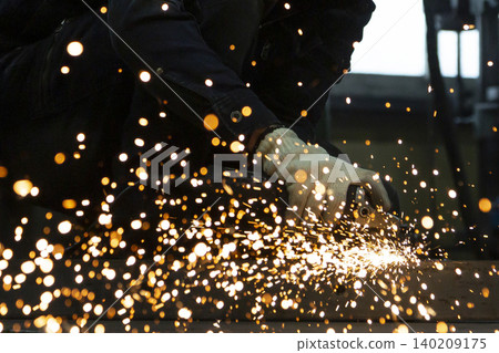 A close-up shot of a metal grinder, with a large amount of sparks flying. A close-up shot of a metal grinder, with a large amount of sparks flying. 140209175