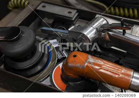 Air tools such as air sanders and air grinders stored in a toolbox Air tools such as air sanders and air grinders stored in a toolbox 140209369