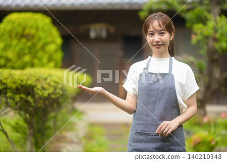 Female staff member giving a tour in a traditional Japanese house Female staff member giving a tour in a traditional Japanese house 140210348