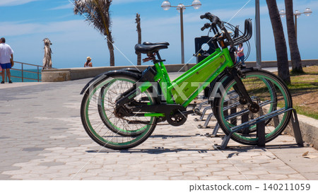 Mazatlan, Mexico - May 14, 2019: Electric vehicle. Rental bicycle of Vbike parked in the street. Electric bike or bicycle. Electric bicycle for rent. Vbike. Electric bike rental Vbike, copy space 140211059