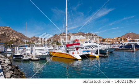 Cabo San Lucas, Mexico - May 15, 2019: Vacation on summer. Catamaran at sea marina. Sea travel. Catamaran sailing in sea. Luxury catamaran yacht in bay. Summer vacation. Luxury travel life Cabo San Lucas, Mexico - May 15, 2019: Vacation on summer. Catamaran at sea marina. Sea travel. Catamaran sailing in sea. Luxury catamaran yacht in bay. Summer vacation. Luxury travel life 140211060