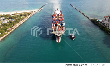 Container ship. Export and import. Cargo business. Port of Miami. Cargo ship with container, aerial view. Freight container on cargo vessel. Cargo ship vessel leaving port. Industrial shipping lanes 140211069