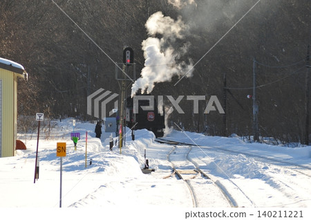 The SL Winter Marshland Train departs from the station, which is covered in snow. The SL Winter Marshland Train departs from the station, which is covered in snow. 140211221