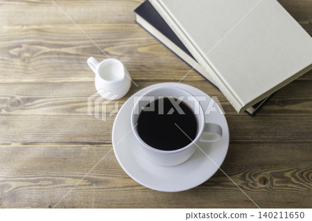 Enjoying coffee while reading a book 140211650