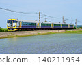 The limited express train "Ayame" passes through rice paddies in early summer. 140211954