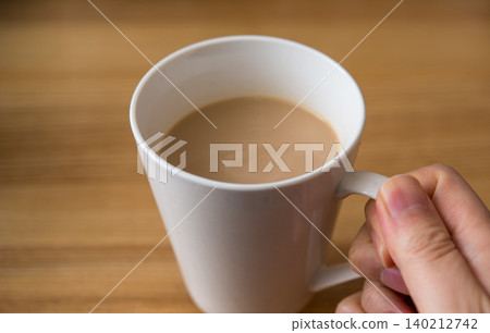 Hand with a mug Hand with a mug 140212742
