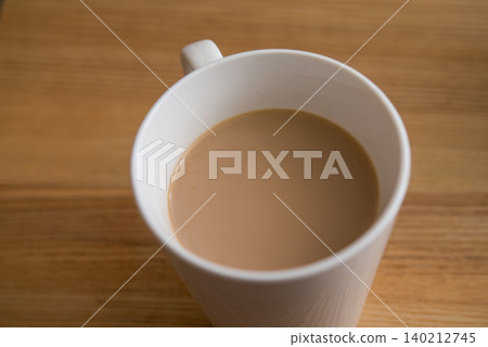 White mug on a wooden desk White mug on a wooden desk 140212745