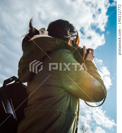 A woman taking photos outdoors A woman taking photos outdoors 140212772