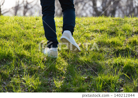 Footsteps walking on the grass Footsteps walking on the grass 140212844