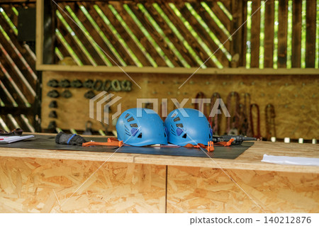Protective sports helmets at reception desk at climbing amusement park Protective sports helmets at reception desk at climbing amusement park 140212876