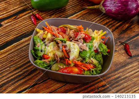 Fresh tuna salad with vegetables in bowl on rustic wooden table 140213135