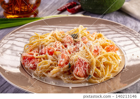 Spaghetti pasta with creamy tomato sauce and grated parmesan cheese Spaghetti pasta with creamy tomato sauce and grated parmesan cheese 140213146