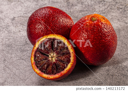 Ripe Blood Oranges Whole and Halved on Grey Stone Background Ripe Blood Oranges Whole and Halved on Grey Stone Background 140213172