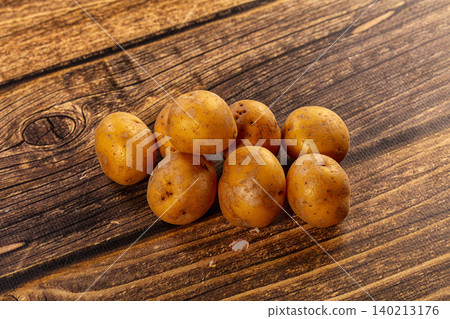 Fresh Raw Unpeeled Potatoes on Rustic Dark Wood Table Fresh Raw Unpeeled Potatoes on Rustic Dark Wood Table 140213176