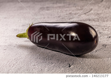 Fresh raw purple eggplant vegetable on grey textured background Fresh raw purple eggplant vegetable on grey textured background 140213177