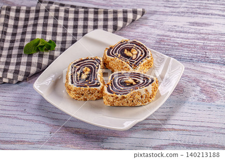 Turkish delight rolls with peanuts and sesame seeds on white plate Turkish delight rolls with peanuts and sesame seeds on white plate 140213188