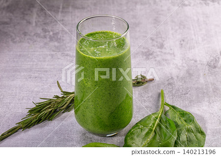 Healthy green smoothie with fresh spinach and rosemary on gray textured background Healthy green smoothie with fresh spinach and rosemary on gray textured background 140213196