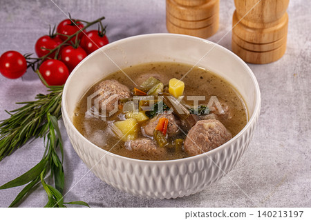 Hearty meatball soup with potatoes and vegetables in white bowl Hearty meatball soup with potatoes and vegetables in white bowl 140213197