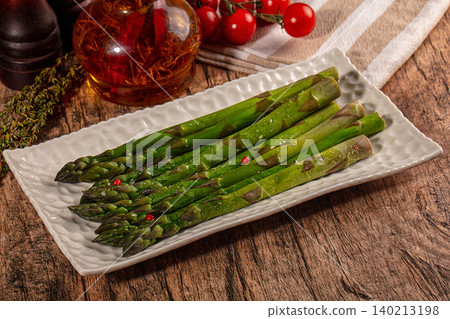 Steamed asparagus appetizer with spices and fresh vegetables on white plate Steamed asparagus appetizer with spices and fresh vegetables on white plate 140213198
